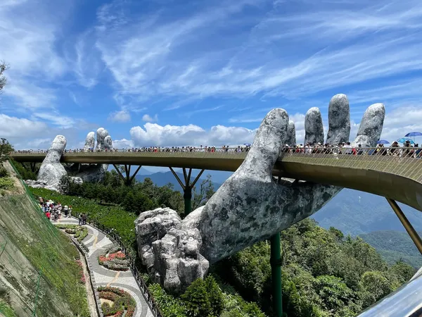 The Golden Bridge in Da Nang, Vietnam - a pedestrian bridge "held" by two large stone hands